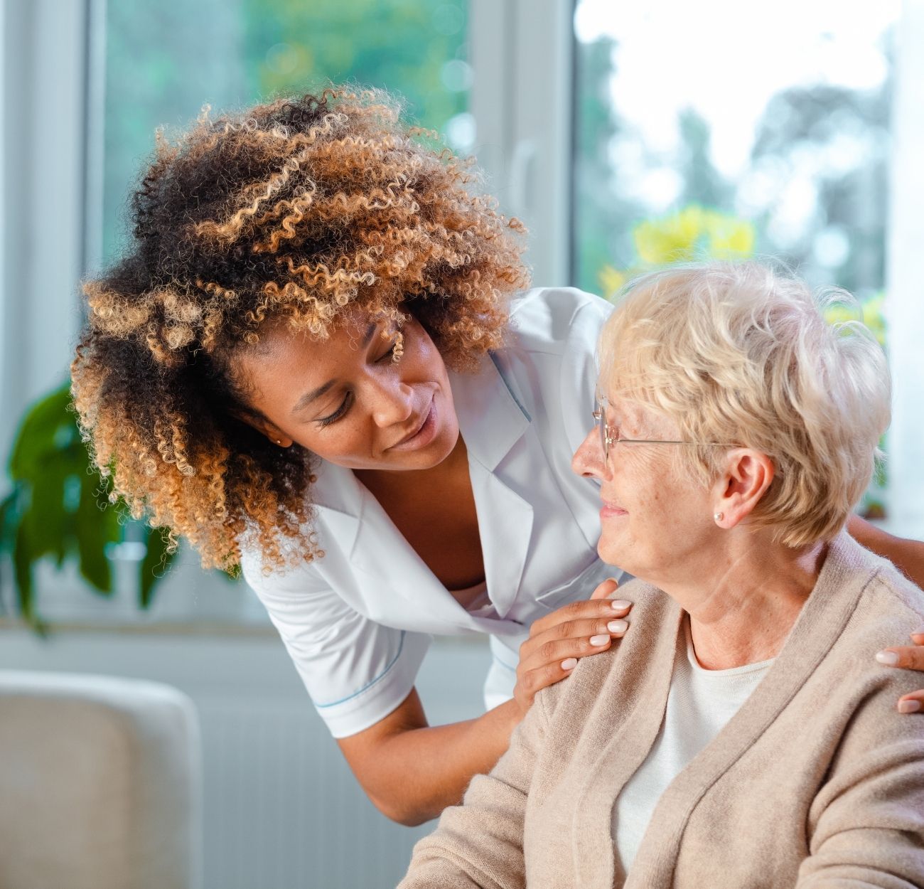 Caregiver holding hands with senior client